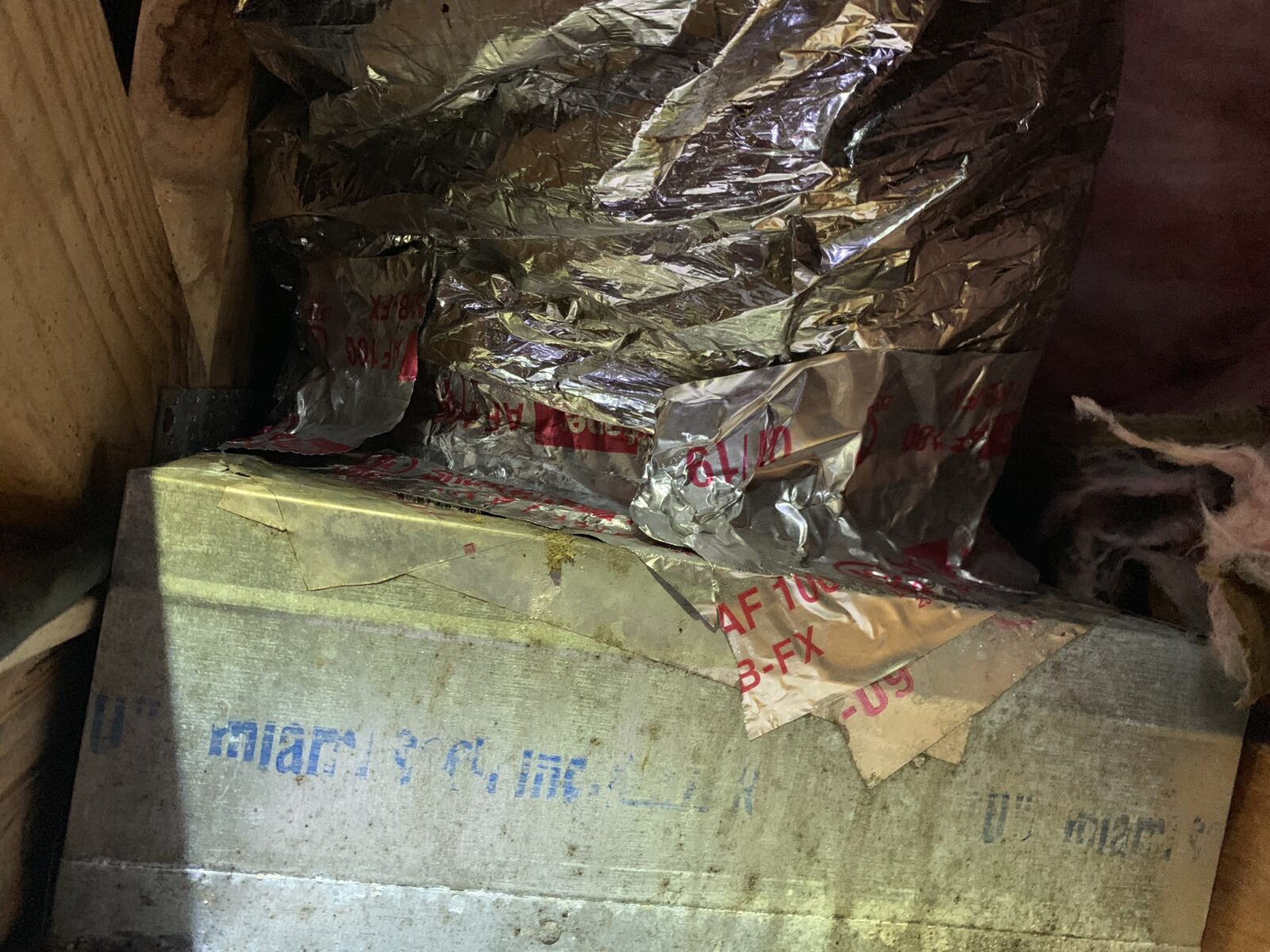 Old foil-faced flexible duct and a stamped ductboard plenum in a cramped attic