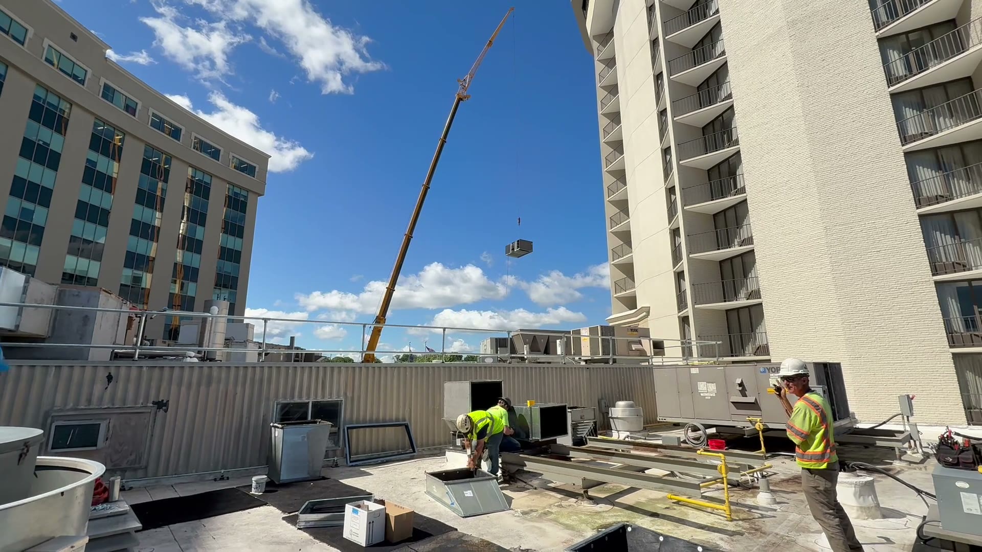 A 100-ton crane lifting a 20-ton York rooftop unit off a casino roof